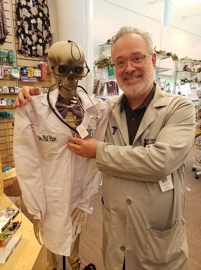 Dr. Smith with an arm around a lab-coated skeleton named Dr. Phil Pain